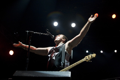 The bassist for Manu Chao encourages the crowd to clap along.
