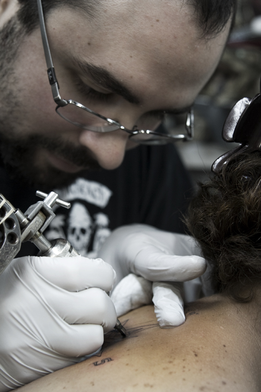 Different girl, same tattoo. In fact, three ladies were getting the matching tats when I stopped in. What's the symbolism? They met on a fishing boat in Kodiak.