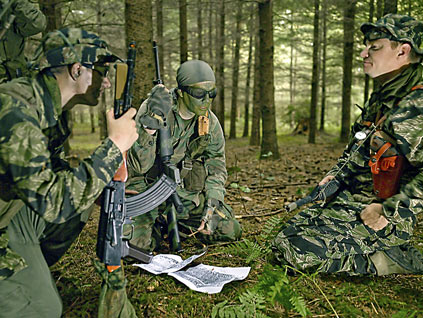 Some 20 guys, as young as 12 and as old as 42, have come to a thickly wooded, privately owned parcel of land on Fox Island, just west of Gig Harbor, to pretend they're in the Vietnamese jungle, on a mission to win the hearts and minds of the locals while training them to battle the Vietcong and North Vietnamese.
