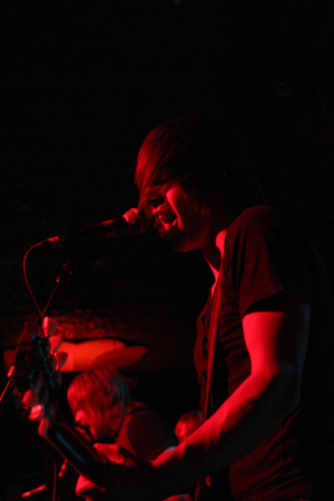 TCC guitarist Robbie Negrin plays and sings during the band's set.