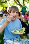 Clark gets a mouthful of salad--salad in a taco shell bowl. Mmmmm...