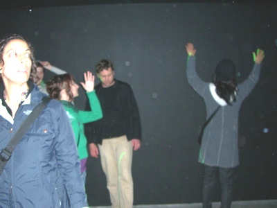 People playing in the laser installation at SOIL by Iole Alessandrini, Ed Mannery, and Ben McAllister.