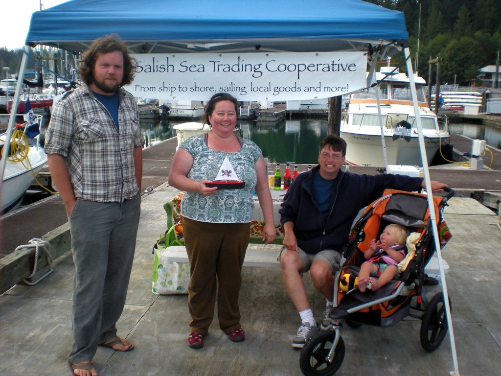 Kathy Pelish, center, relies on collaborators like Frank Calma, left, and Mark Hulscher to make Salish Sea Trading go.