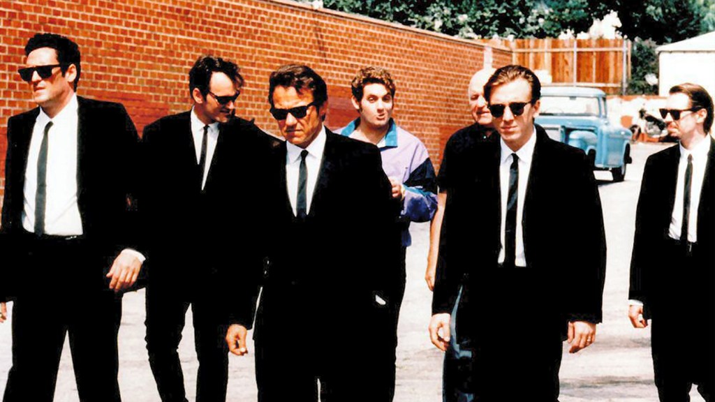 From left, Michael Madsen, Tarantino, Keitel, Chris Penn, Lawrence Tierney, Roth, and Buscemi take their Reservoir Dogs stroll.