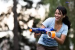 Caitlin Singer dodges a foam dart while advancing on a group of red team members.