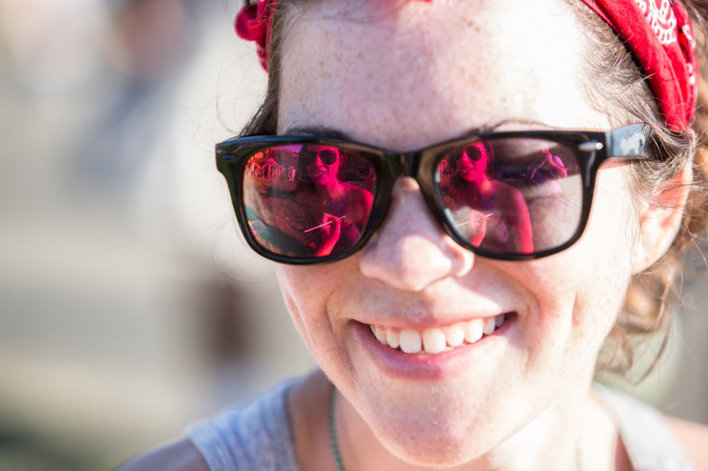 Local artist Aleena Ober paints a figure onto the chest of Katie Tumbull during the Hempfest 2013 in Seattle.