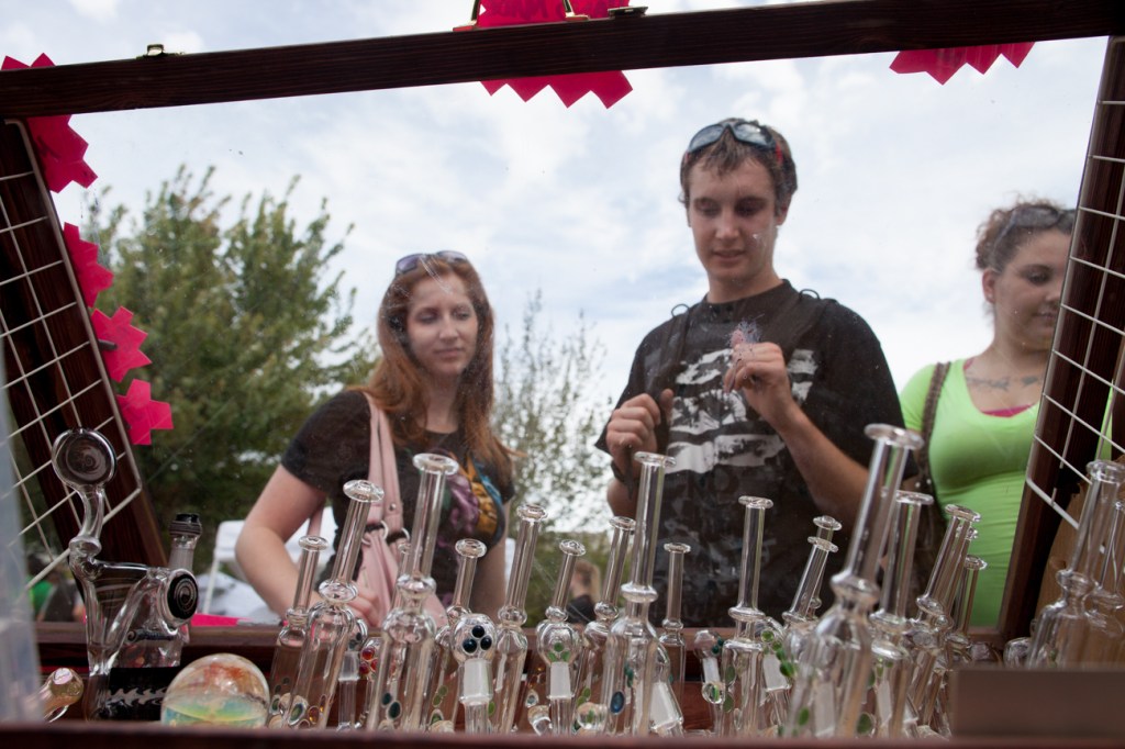 Passerby take a gander at a selection of pipes for sale in a display booth on Saturday.