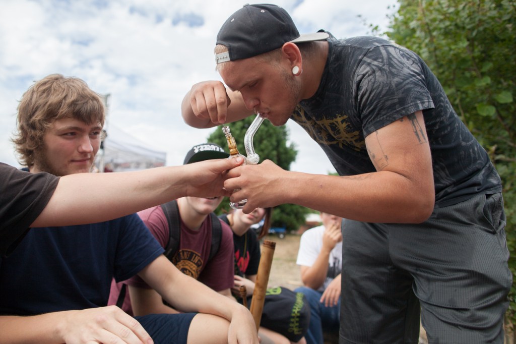 A group of young men light up and take a hit on Saturday.