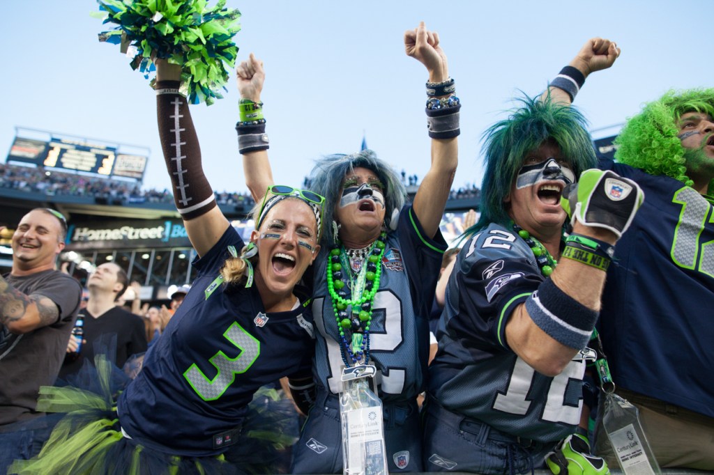 Several die hand Seahawks fans celebrate a Seattle touchdown early in the game.