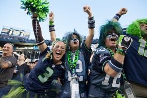 Several die hand Seahawks fans celebrate a Seattle touchdown early in the game.