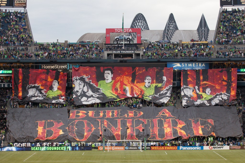 The Emerald City Supporter superfans unravel a huge tifo prior to the Cascadia Cup match in Seattle, WA on August 25, 2013. An announced crowd of 67,385 - one of the largest ever in MLS history - turned out for the epic rivarly match.