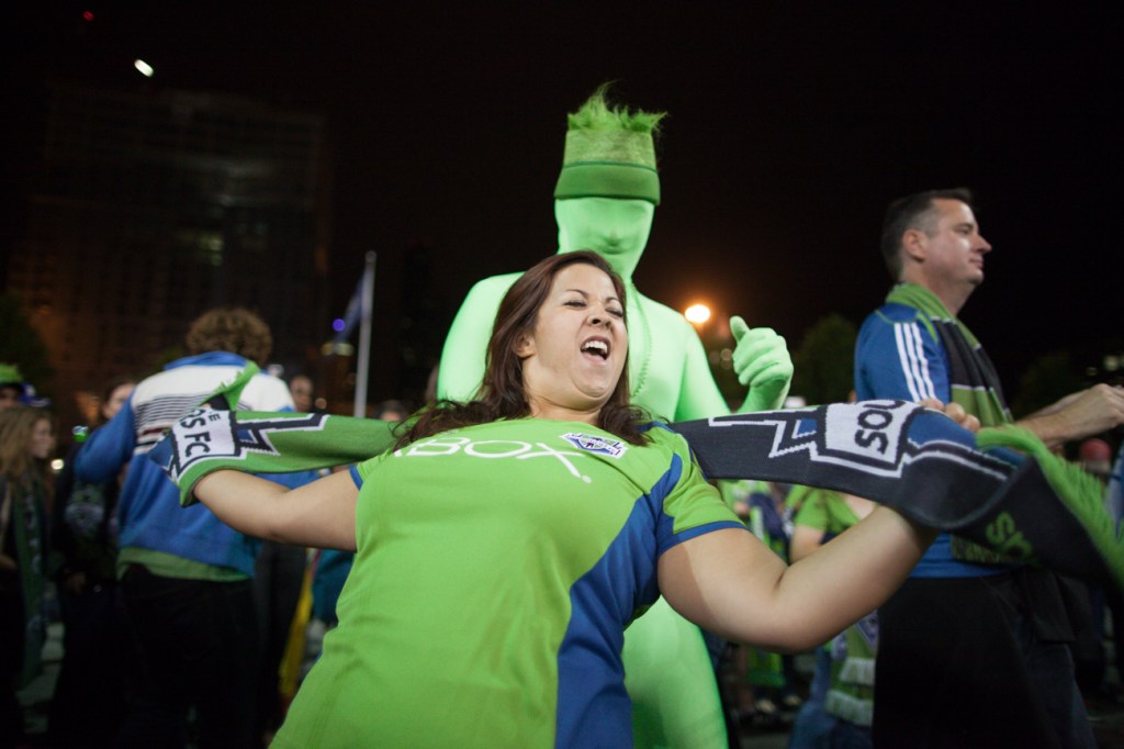Sounder fans dance outside the stadium after the game.