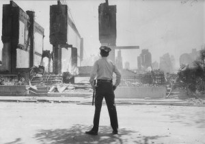 Following the fiery raid, a Philadelphia cop surveys the scene.