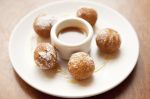 Rice pudding fritters, which magically combine the brilliance of pudding and doughnuts at Agrodolce (Photo by Joshua Huston)