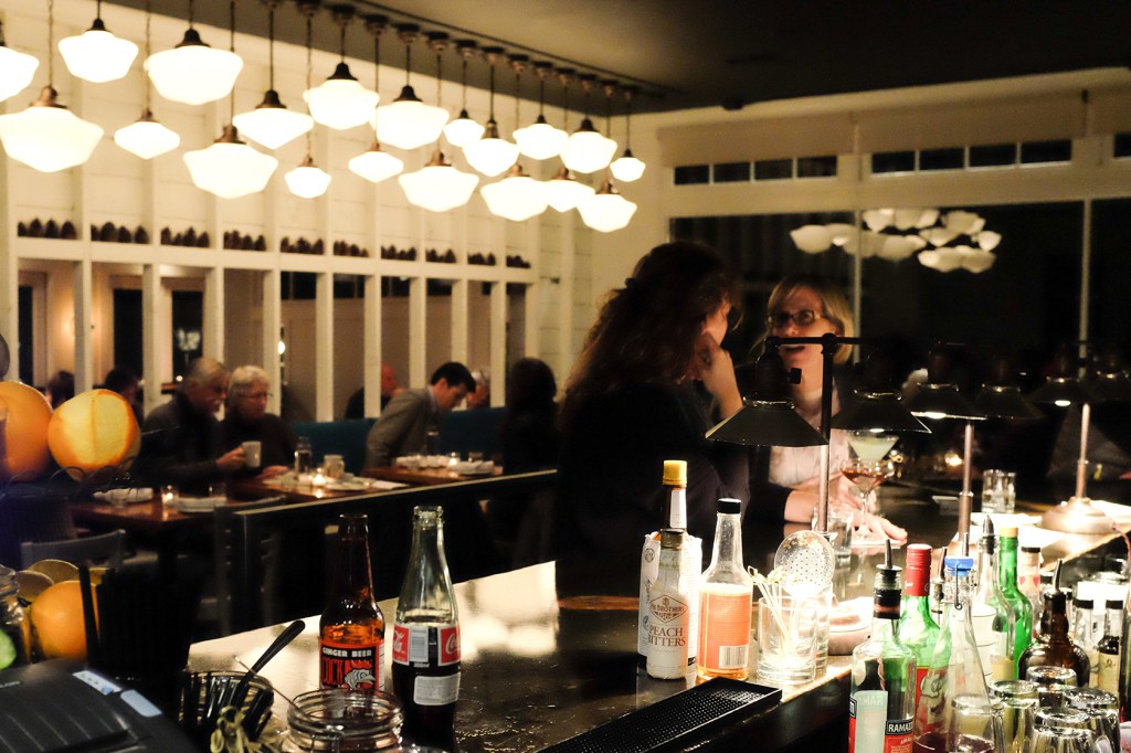Top, a warm vibe. Bottom left, bartender Jeff Steiner. Bottom right, a floor of shiny pennies.
