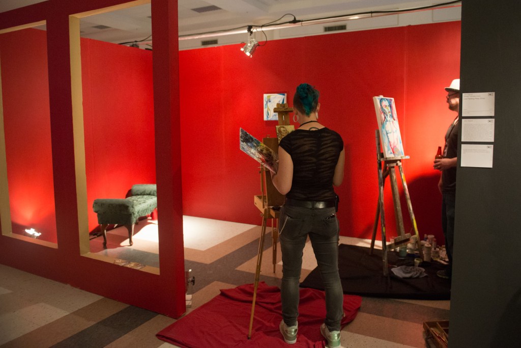 Live painting by John Osgood and Seb Barnett, allowing viewers to become part of the art by sitting for them