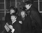 The Fab Four prepare for a take.