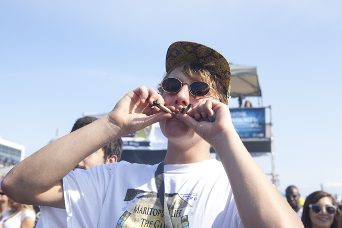 In celebration of 4:20 p.m., a man smokes out of four different joints. Photo by Anna Erickson