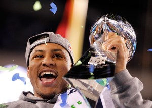 Photo by Jennifer Buchanan / The Herald Malcolm Smith holds the Vince Lombardi Trophy