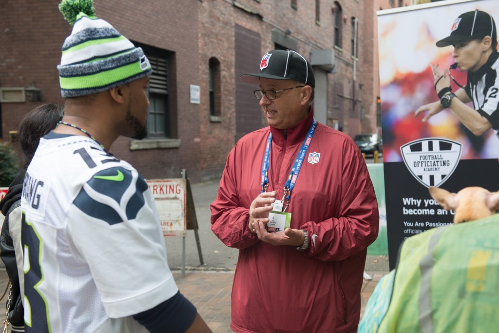 Referees talking it up with fans and possibly recruiting future ref. Photo by Morgen Schuler