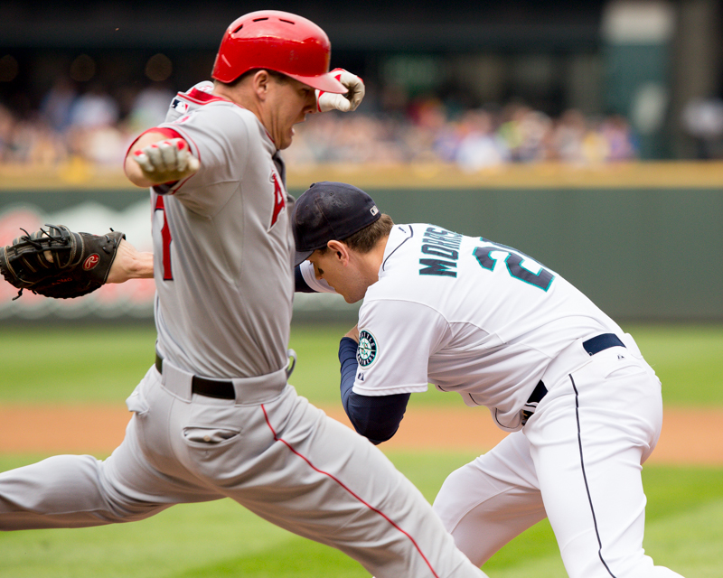 Logan Morrison receives a throw that beats the Angels batter to first base.