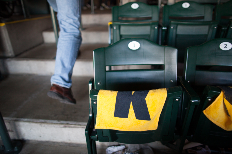 A fan walks past a lonely K towel in an empty chair after Texas forces the Mariners' playoff elimination.