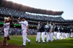 A Mariners player high fives the Mariners Moose after the game.