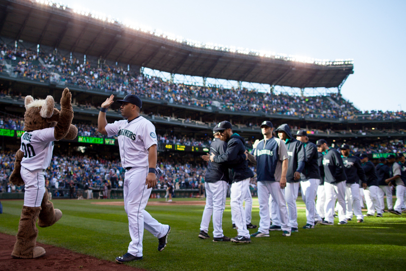 A Mariners player high fives the Mariners Moose after the game.