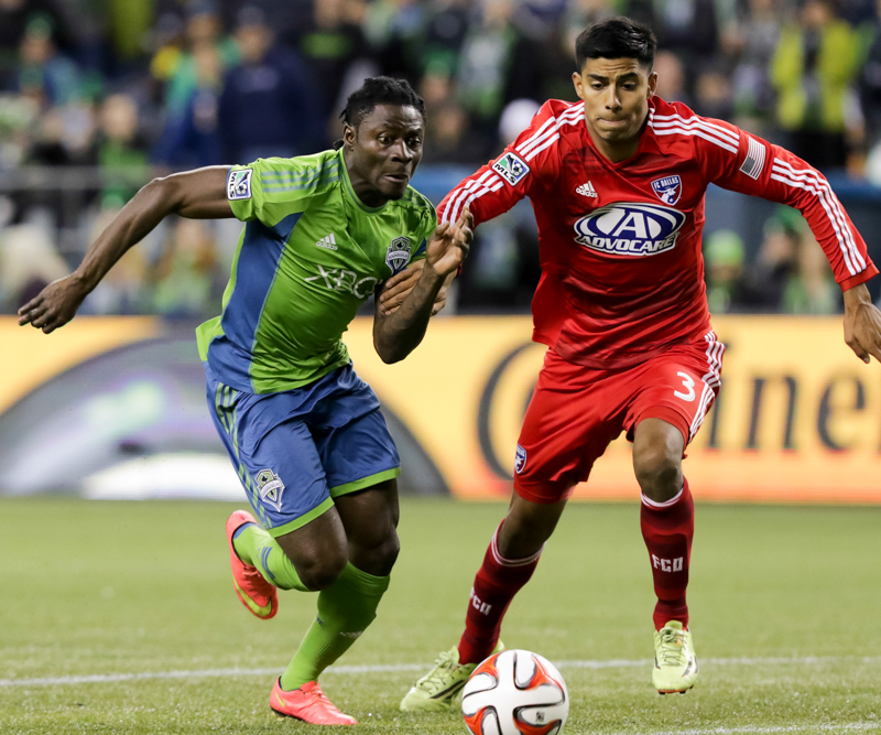 Seattle forward Obafemi Martins tries to break past a Dallas defender as he works toward the goal in the first half.