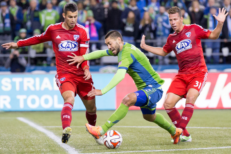 Sounders' forward Clint Dempsey attempts to break past Dallas defenders in the first half.
