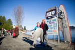 Soon to be plungers pose for photos in front of the official polar plunge sign at Matthews Beach in Notheast Seattle on January 1, 2015.