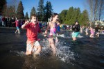 Small children wade into the chilly water.