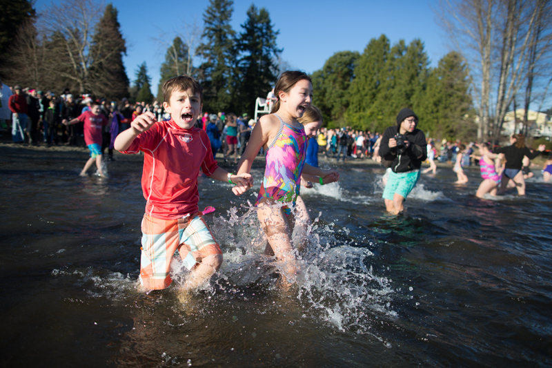 Small children wade into the chilly water.