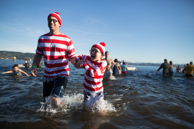 Dressed as Where's Waldo, a father and son duo make their way out of the water.
