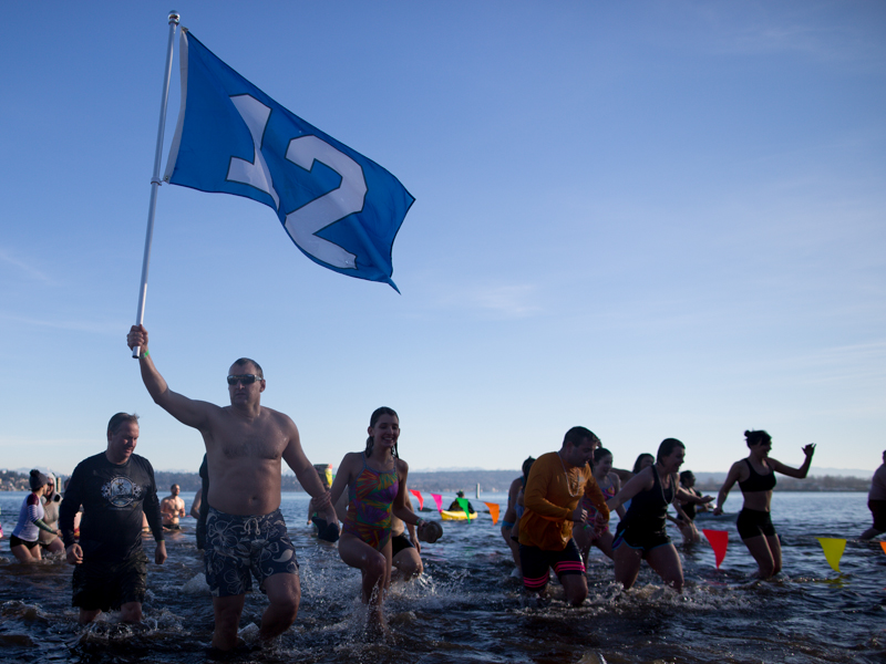 Hoisting a 12-th man flag, a couple slogs through the chilly waters of Lake Washington.