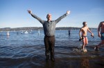 Fully dressed in business casual, a man celebrates his successful dip.