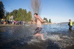 A man rushes to escape the cold water after taking a dunk.