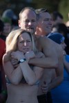 A woman bundles up in the arms of a friend before the plunge.