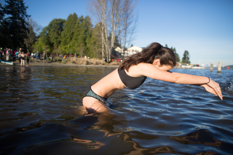A woman takes a dive into the water.