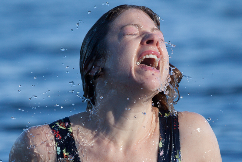 A brave soul tries to shake off the freezing water after taking her dip.