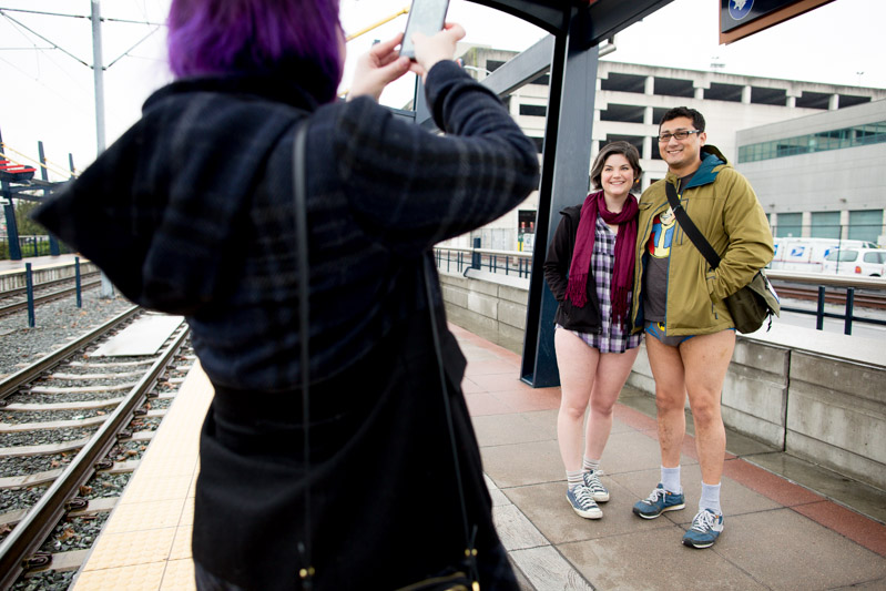 Looking for proof of participation, a couple has their photo taken on a platform.