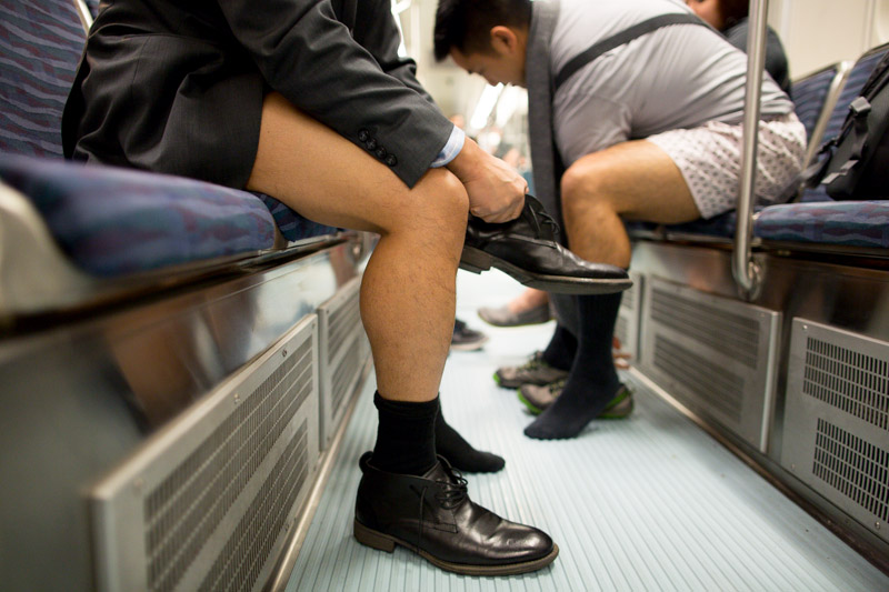 Shoes are readjusted onto feet after a few gentlemen change out of their pants.
