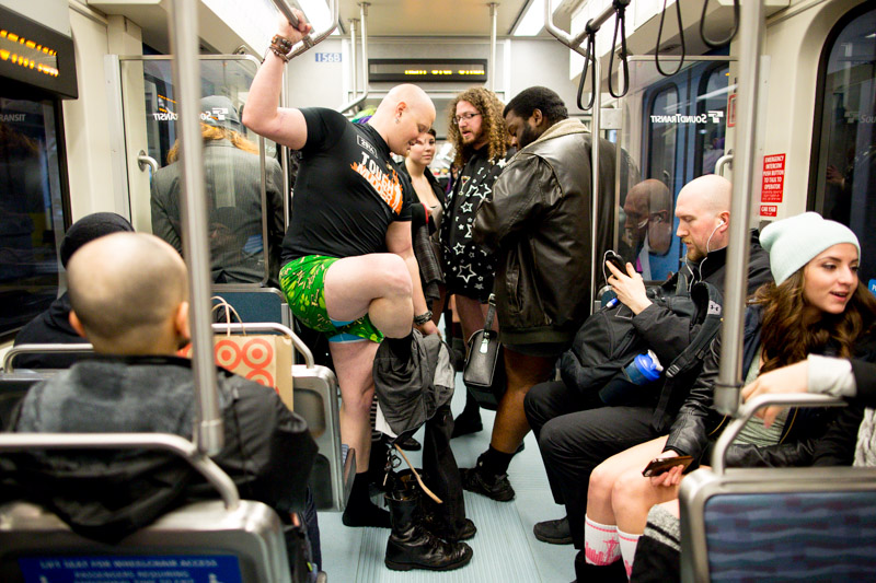 A participant removes his pants on board the Link light rail train.