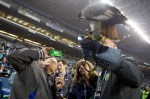 Washington State Governor Jay Inslee snaps a photo of the Seahawk before the game.