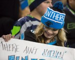 A Panthers fan readies her sign for action before the game.