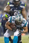 Seattle defenders pile onto Panthers' running back Jonathan Stewart as he runs for 4 yards in the first quarter.