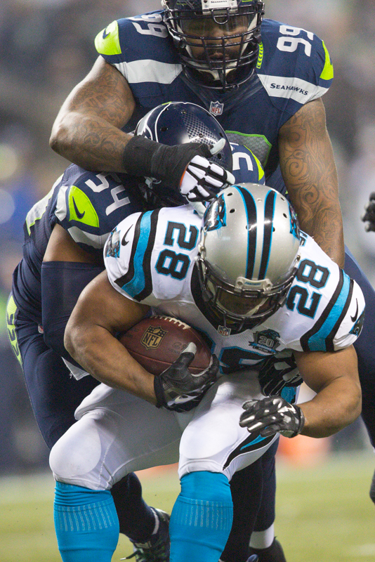 Seattle defenders pile onto Panthers' running back Jonathan Stewart as he runs for 4 yards in the first quarter.
