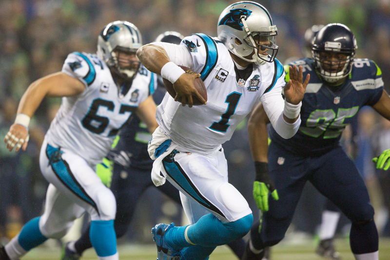 Panthers quarterback Cam Newton scrambles right for a 4 yard gain in the first quarter.
