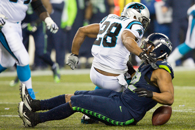 Players rush to grab a Cam Newton fumble in the first quarter.
