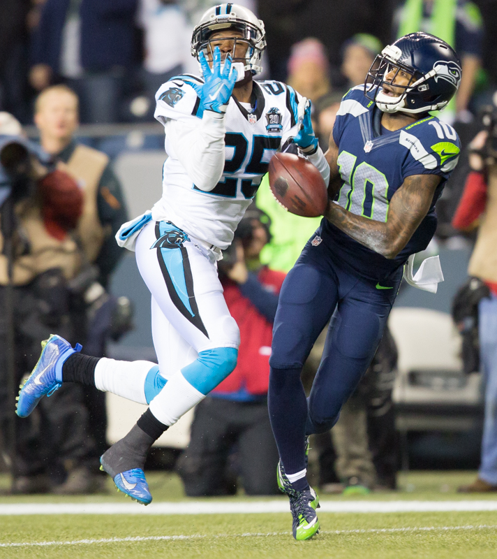 Seattle receiver Paul Richardson struggles to fend off a Panther receiver in the third quarter. Richardson was injured on the play and did not return in the game.